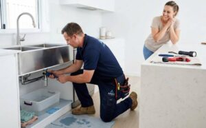 Emergency plumbing service fixing burst pipe in residential home